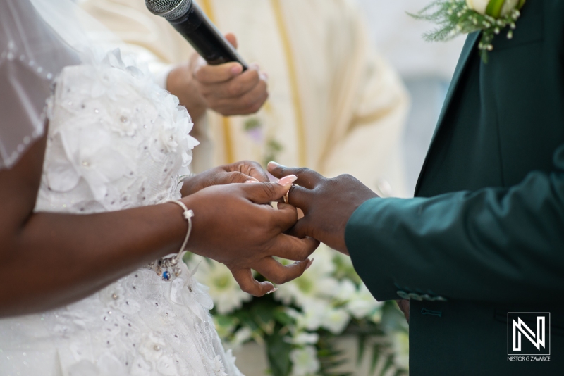 Bride and groom exchanging wedding rings in the church ceremony