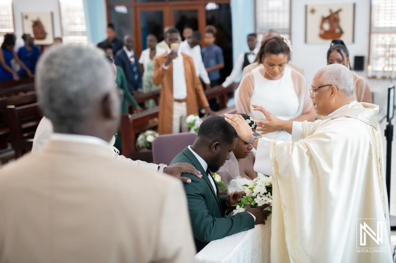 Priest giving his blessing to the couple in the wedding ceremony