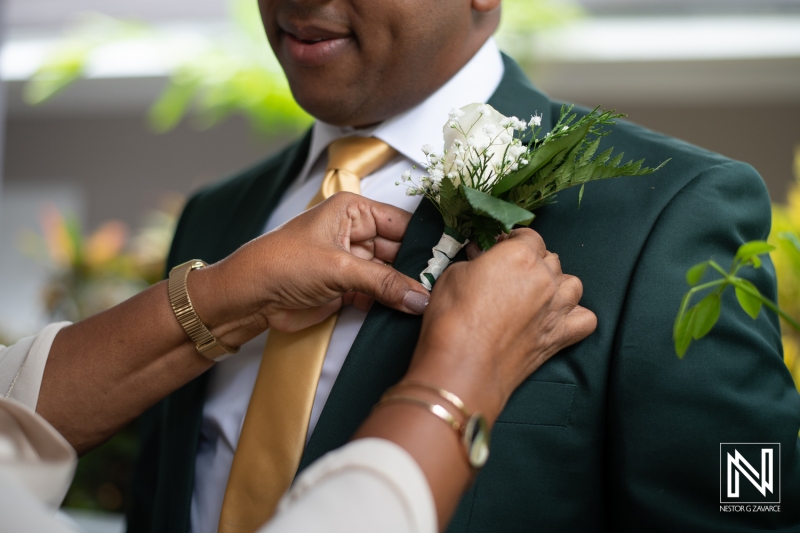 Groom getting into attire