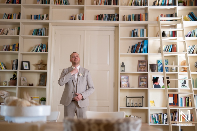 Groom preparing for wedding celebration at Landhuis Klein Santa Martha in Curacao surrounded by a stylish interior