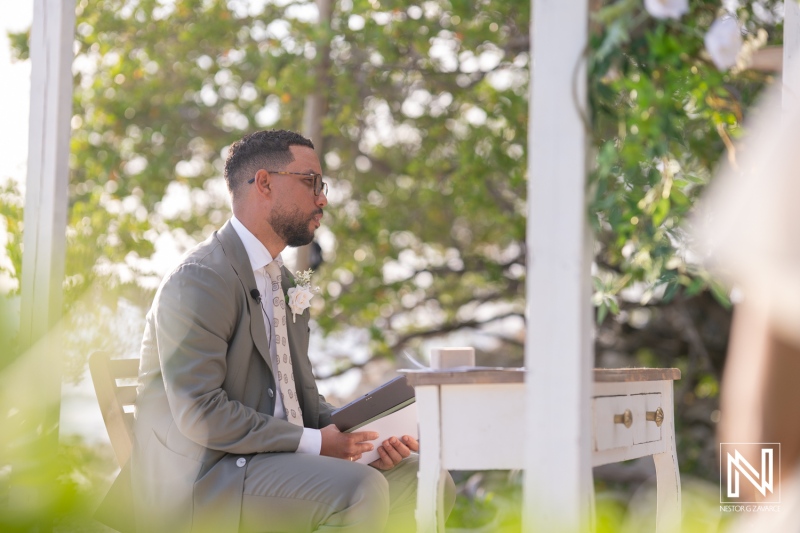 Celebratory wedding ceremony at Landhuis San Nicolas in Curacao featuring a groom waiting at the altar