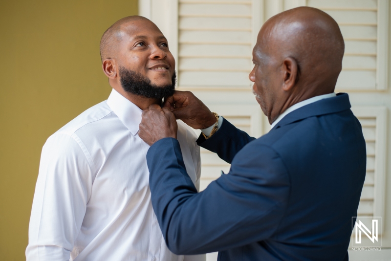 Groom getting into attire