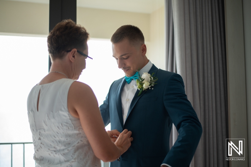 Groom getting into attire
