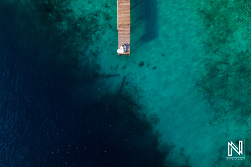 Drone shot of bride and groom at the pier