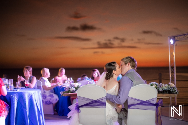 Bride and groom kiss at the reception