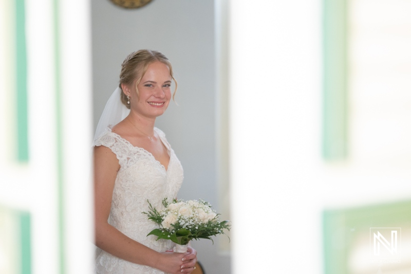Wedding celebration in Curacao during Misa Di Jandoret with a joyful bride holding a bouquet in a charming setting