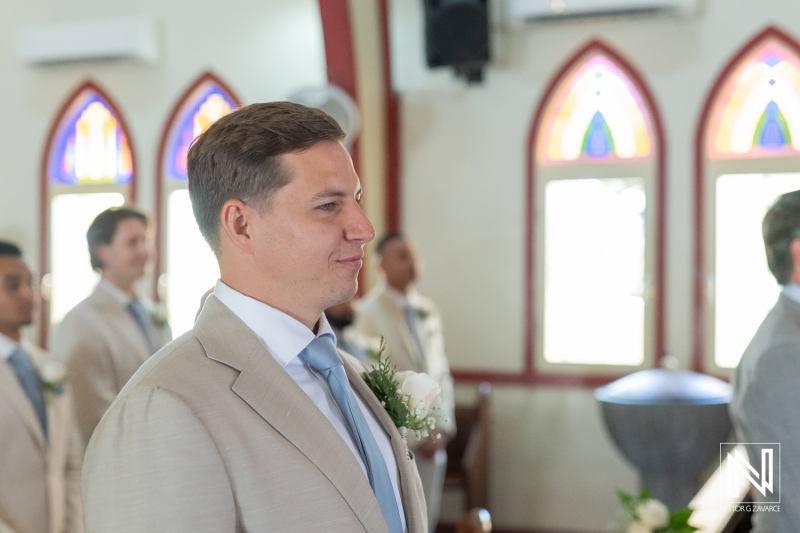 Wedding ceremony in Curacao during Misa Di Jandoret with groom and groomsmen celebrating love and joy on a beautiful day