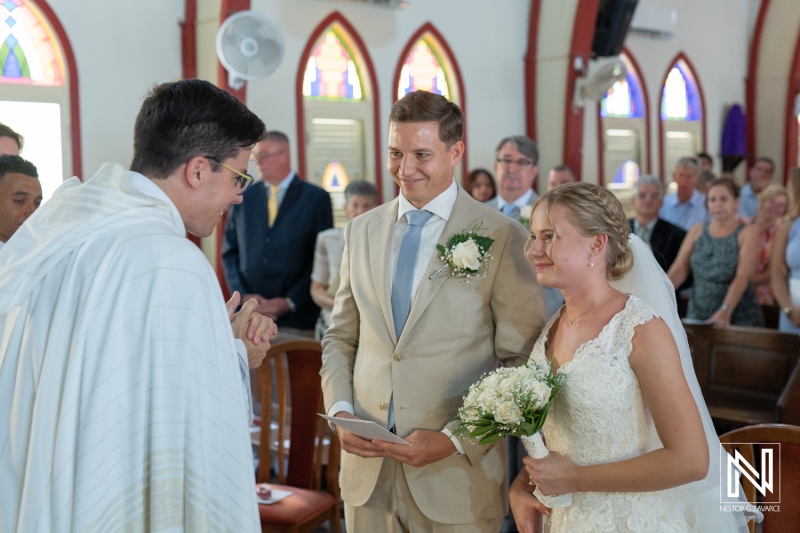 Couple exchanges vows during wedding ceremony in beautiful Curacao church at Misa Di Jandoret