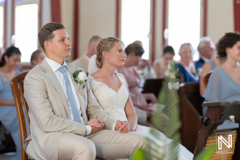 Couple celebrates their wedding during Misa Di Jandoret in Curacao, surrounded by family and friends