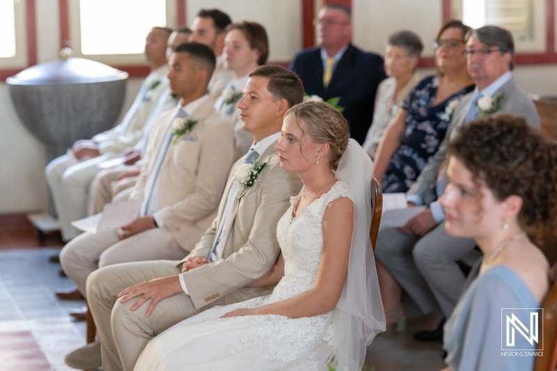 Wedding celebration at Misa Di Jandoret in Curacao features an intimate gathering of family and friends during the ceremony