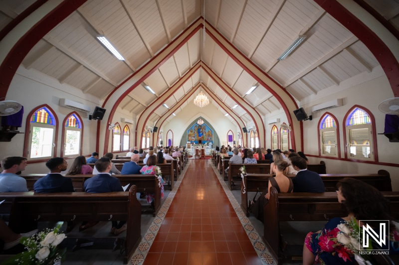Wedding ceremony at Misa Di Jandoret in Curacao with family and friends gathered in a beautiful church setting