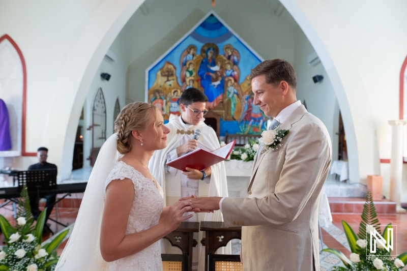 Couple exchanges vows during a wedding ceremony at Misa Di Jandoret in Curacao surrounded by friends and family