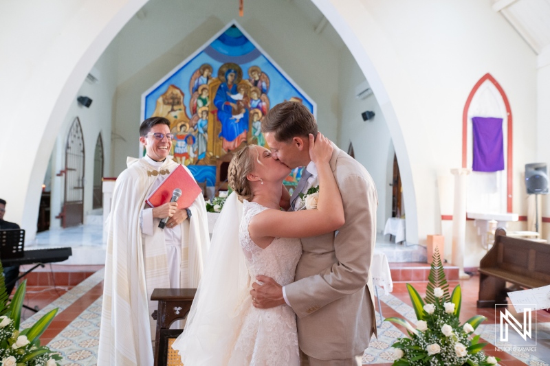 Couple exchanges vows during their wedding ceremony in Curacao at Misa Di Jandoret surrounded by family and friends