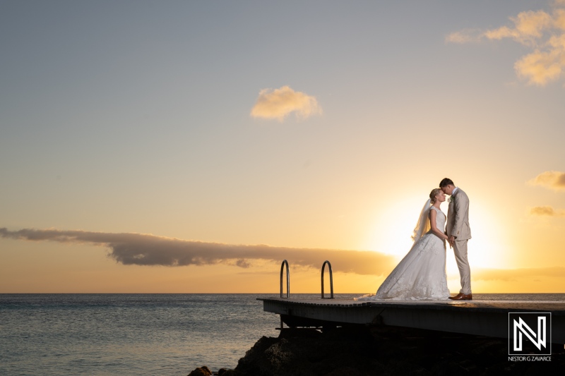 Couple exchanges vows during a sunset wedding on the serene Playa Porto Mari in Curacao