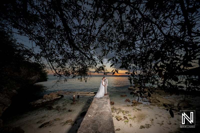 Couple celebrates their wedding bliss at the beautiful Playa Porto Mari in Curacao during a stunning sunset