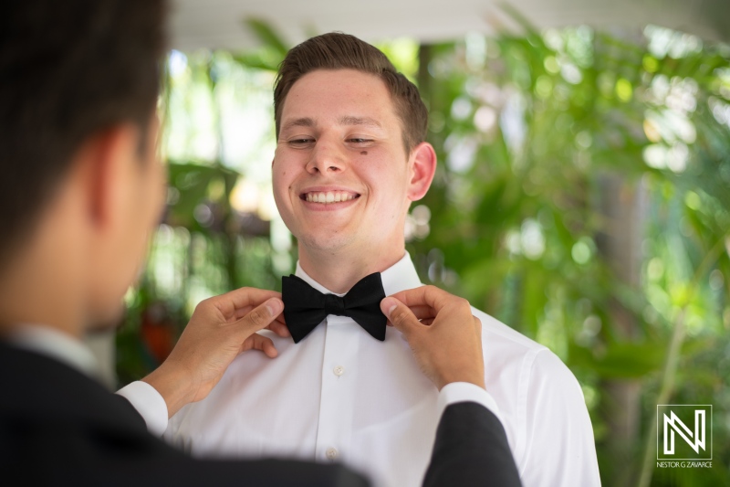 Groom getting into attire