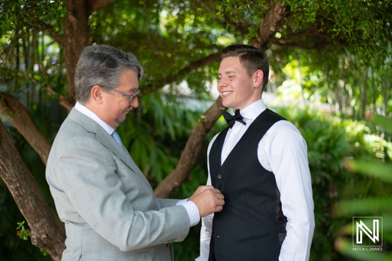 Groom getting into attire