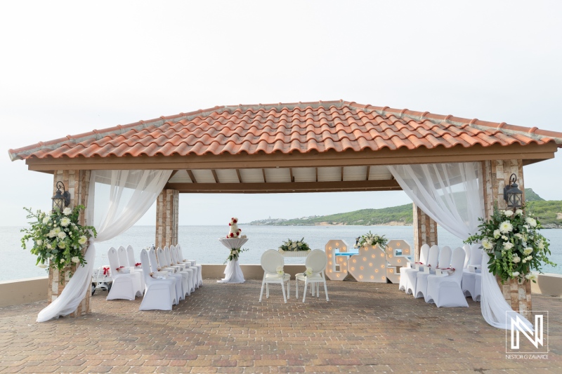Wedding setup at Dreams Curacao Resort by the sea with chairs and decorations ready for the ceremony