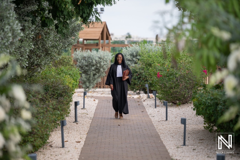 Walking along the path at a wedding in Dreams Curacao Resort surrounded by green plants and flowers