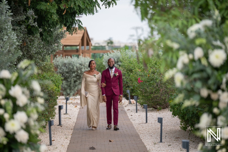 Couple walks down path at wedding event in Dreams Curacao Resort during a sunny day in Curacao