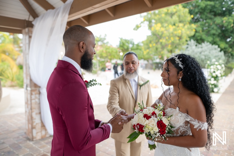 Wedding ceremony at Dreams Curacao Resort with a couple exchanging vows under a shelter at the beach