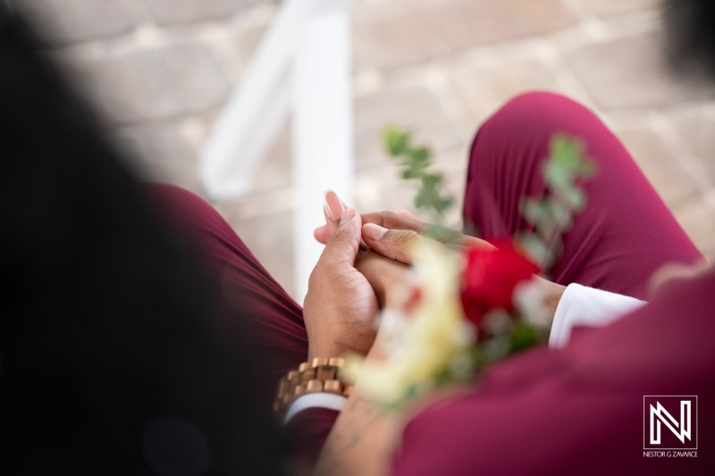 Wedding ceremony taking place at Dreams Curacao Resort with couple holding hands and flowers present