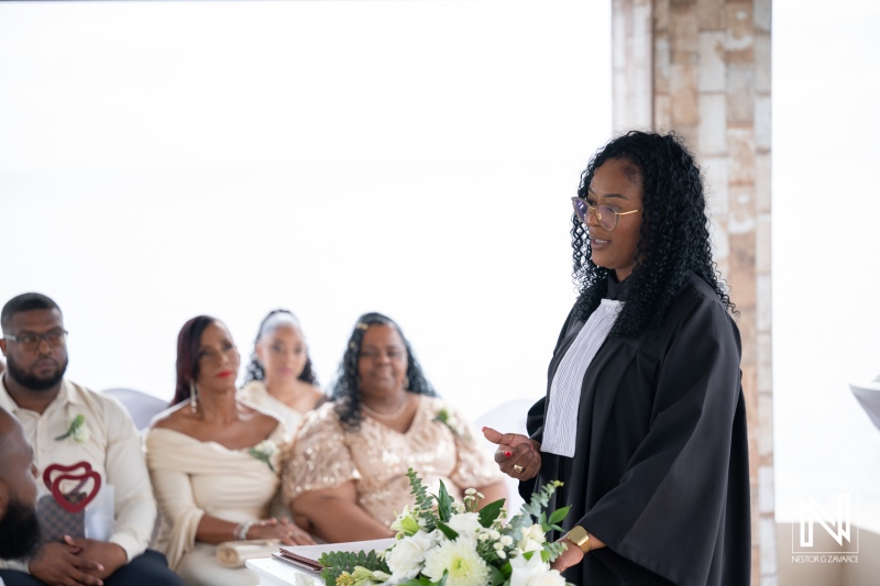 Guests gather for a wedding ceremony at Dreams Curacao Resort overlooking the ocean on a bright sunny day