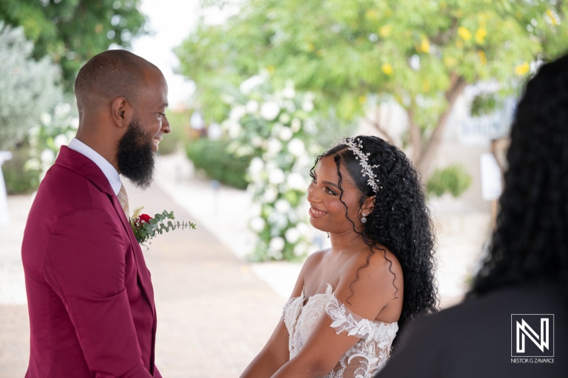 Couple exchanges vows during wedding ceremony at Dreams Curacao Resort surrounded by nature and friends