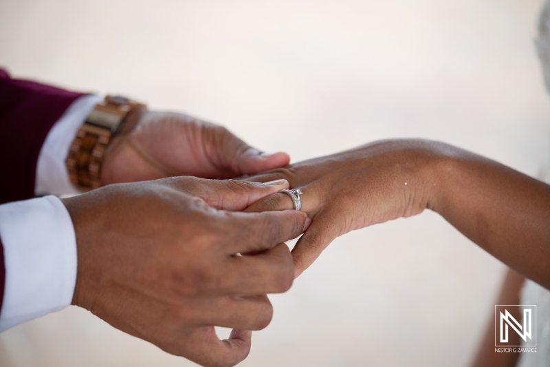 Couple exchanges wedding rings at Dreams Curacao Resort during sunset ceremony