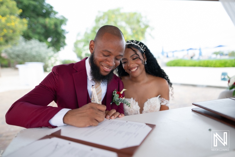 Couple signs wedding documents at Dreams Curacao Resort during their special ceremony in beautiful surroundings