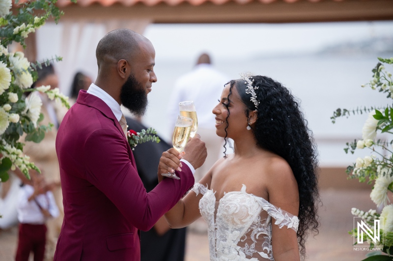 Wedding celebration at Dreams Curacao Resort with couple toasting with champagne