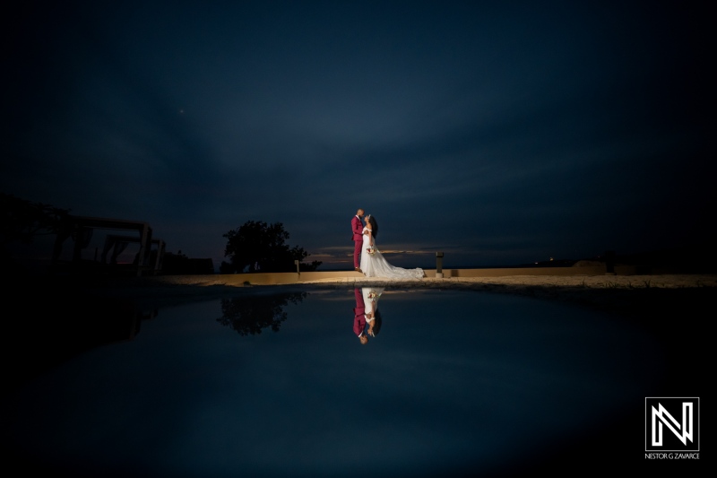 Couple shares a special moment at a wedding in Dreams Curacao Resort under a night sky
