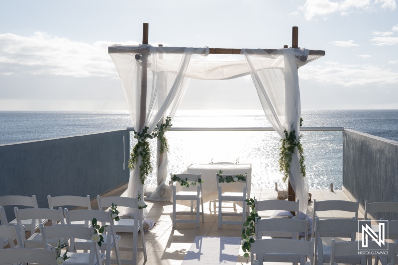 Beautiful wedding setup overlooking the ocean in Curacao at sunset with elegant decorations and serene ambiance