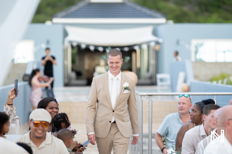 Groom walking confidently towards altar during a beautiful wedding ceremony in Curacao