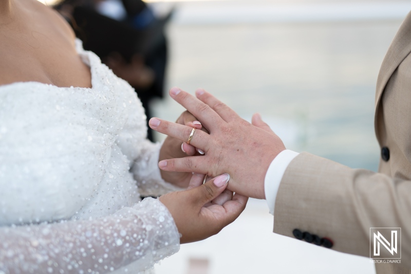 Couples exchange wedding rings during an intimate ceremony in Curacao surrounded by beautiful ocean views