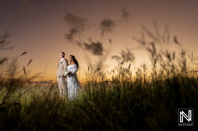 Couple celebrates wedding in scenic Curaçao at sunset surrounded by nature and beautiful sky colors