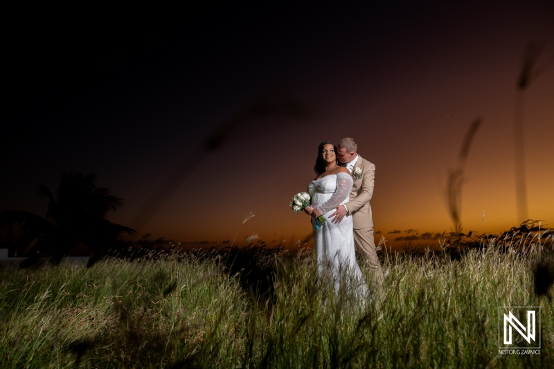 Couple celebrating their wedding in Curacao at sunset amidst beautiful grassland with a romantic atmosphere