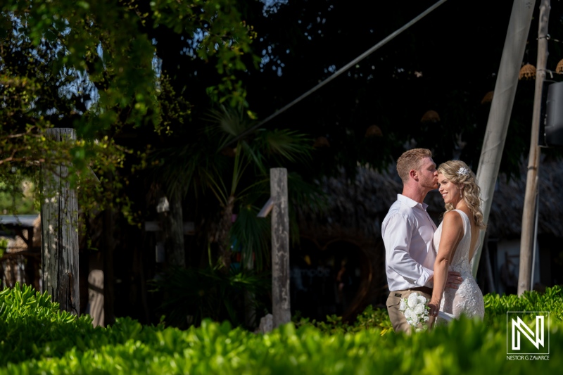 Wedding ceremony at Mood Beach in Curacao during sunny day with couple celebrating their love