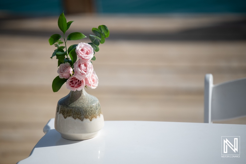 Flowers on a table at a wedding celebration taking place on Mood Beach in Curacao