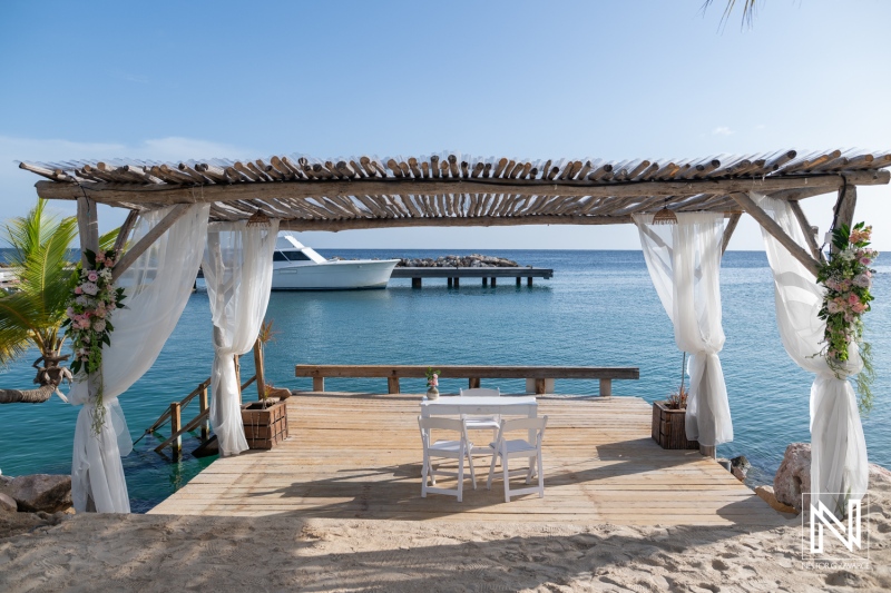 Wedding ceremony setup at Mood Beach in Curacao with a view of the ocean and a white table for vows