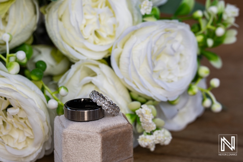 Wedding rings on display with flowers at Mood Beach in Curacao during a beautiful wedding ceremony