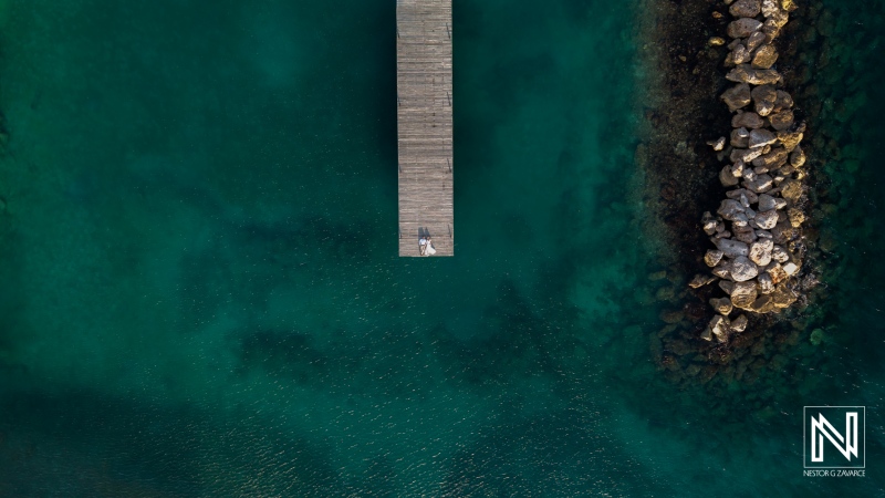 Couple celebrates wedding on a dock at Mood Beach in Curacao under bright sun