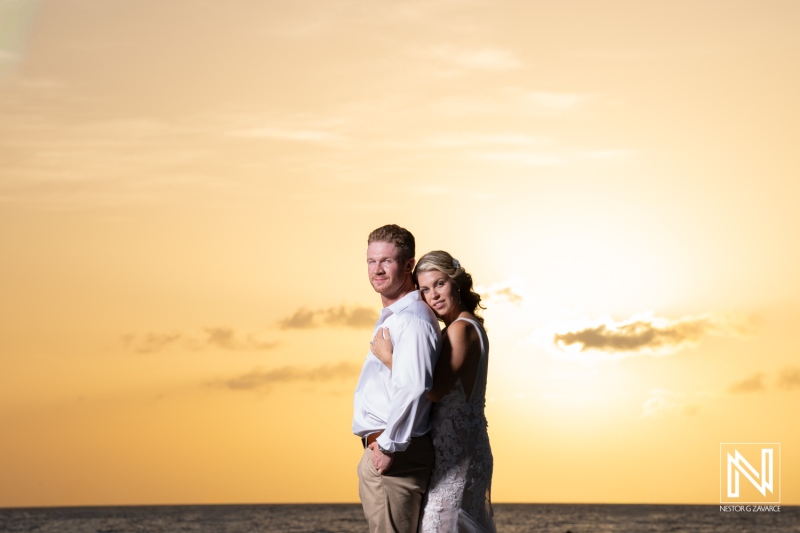 Wedding ceremony at Mood Beach in Curacao during sunset with couple by the ocean