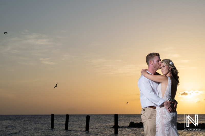 Couple celebrates their wedding at Mood Beach in Curacao during sunset with ocean view and gentle breeze