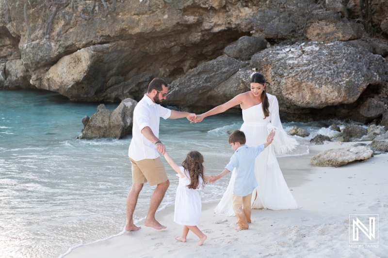 Couple and kids dancing at the beach
