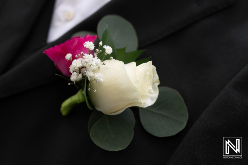 Elegant Floral Boutonniere Featuring White and Pink Roses With Greenery, Perfect for Weddings or Formal Events Captured in Soft Lighting