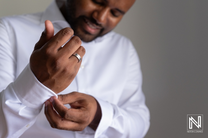 A Man Adjusting His Cufflinks While Wearing a Formal White Dress Shirt, Preparing for a Special Event in a Well-Lit Indoor Setting During the Day