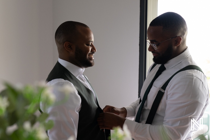 Two Men Preparing for a Special Occasion in a Modern Indoor Setting Wearing Formal Attire on a Bright Day