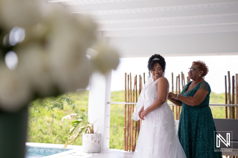 A Bride Prepares for Her Wedding Day While a Family Member Helps Her With the Finishing Touches in a Scenic Outdoor Setting