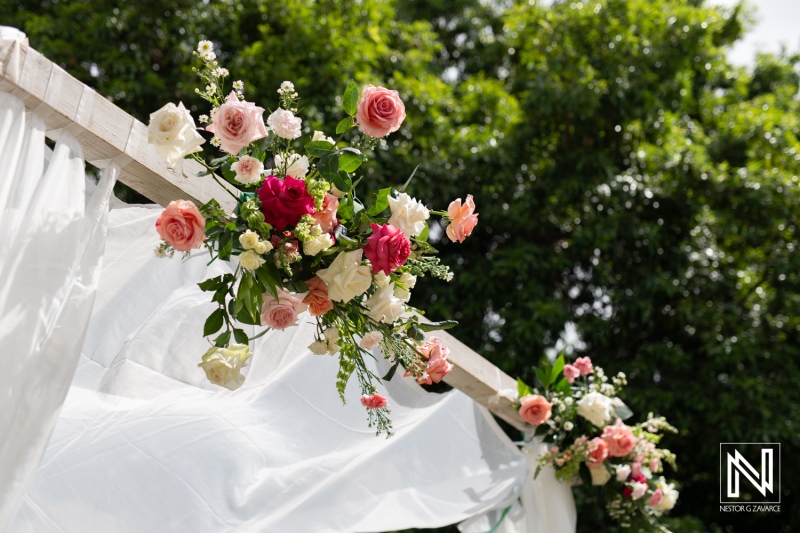 Beautiful Floral Decoration With a Vibrant Color Palette at an Outdoor Venue, Showcasing Roses and Greenery Under a Sunny Sky